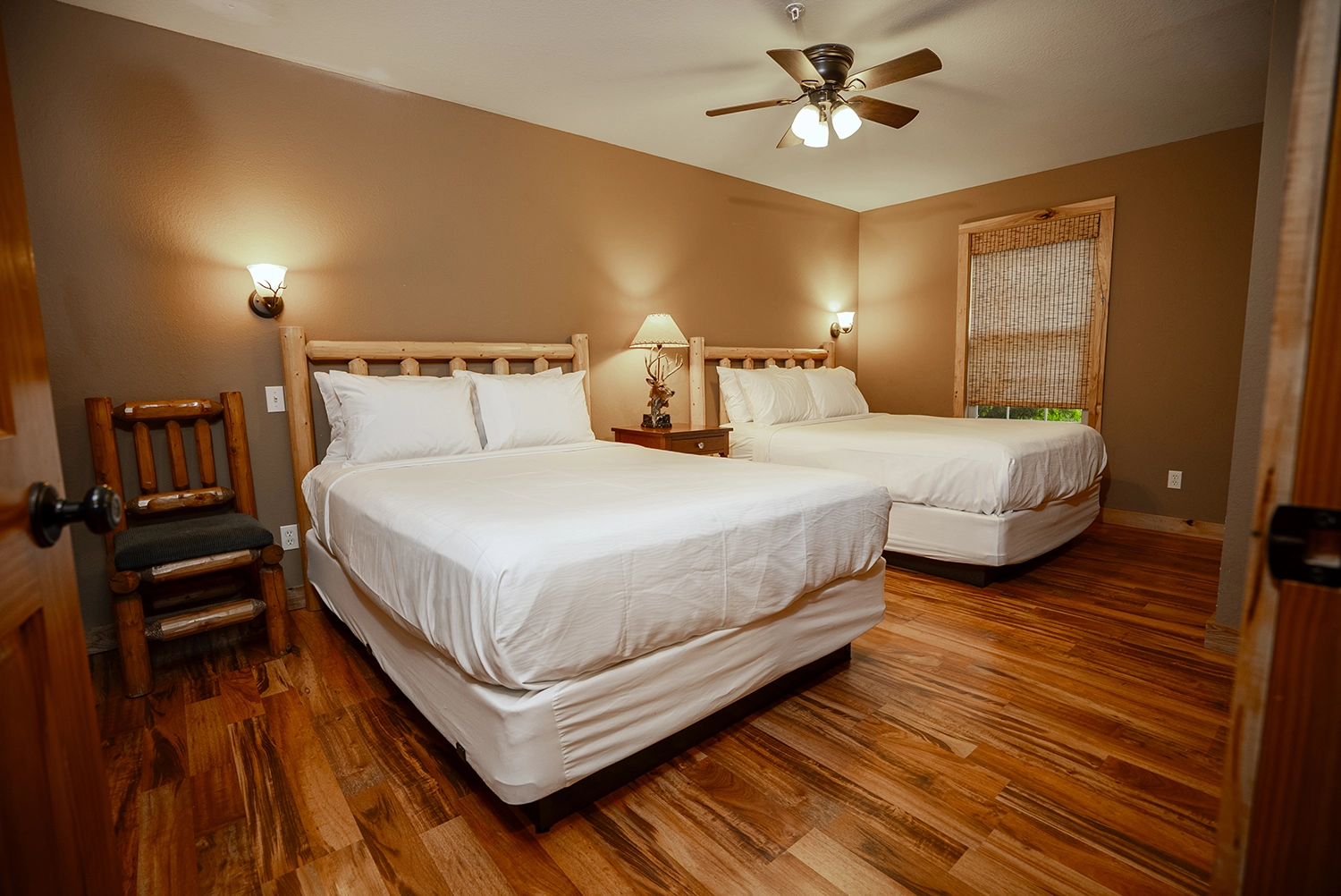 The primary bedroom as seen from the bedroom doorway in a Loft Cabin at Santa's Cottages.
