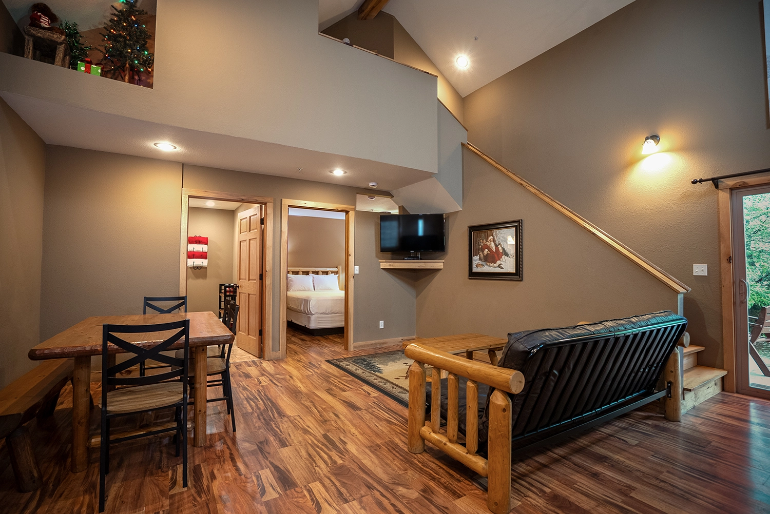 A look at the living room, dining area, and stairway of a Loft Cabin at Santa's Cottages.