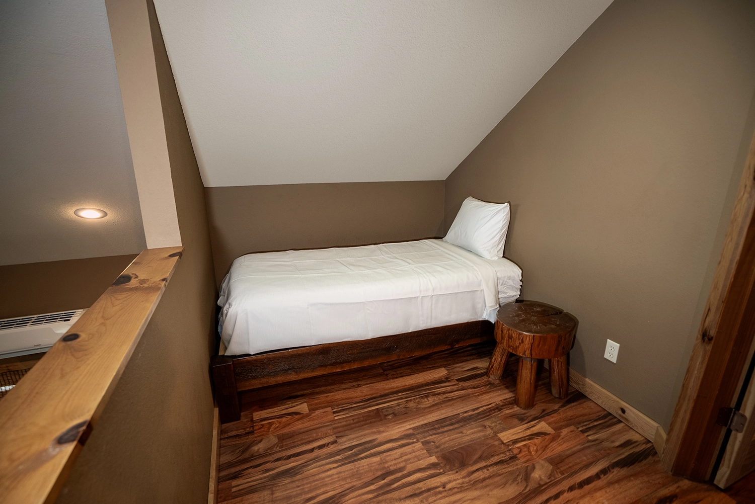 Bed positioned in the loft area of a Cabin at Santa's Cottages.