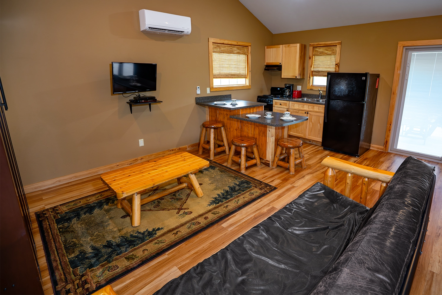 Living Room, Dining Area, and Kitchen of a One-Bedroom Cottage at Santa's Cottages.