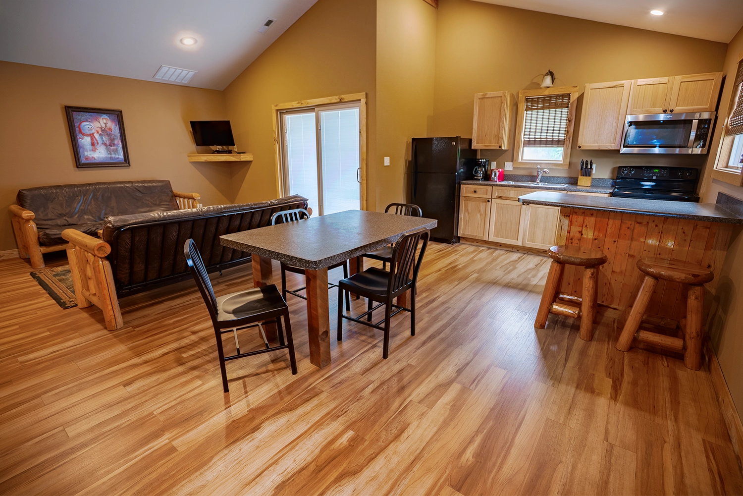 Kitchen, Dining Room, and Living Room of a Stables Cottage at Santa's Cottages.