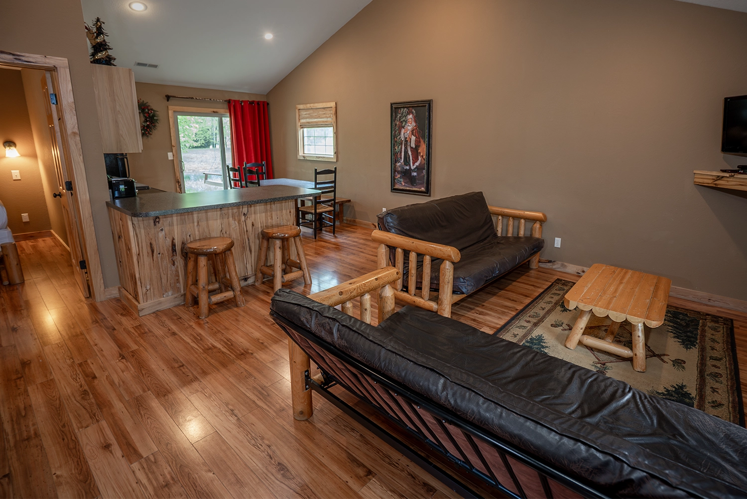 The Living Room, Kitchen, and Dining Area of a Bells cottage at Santa's Cottages.
