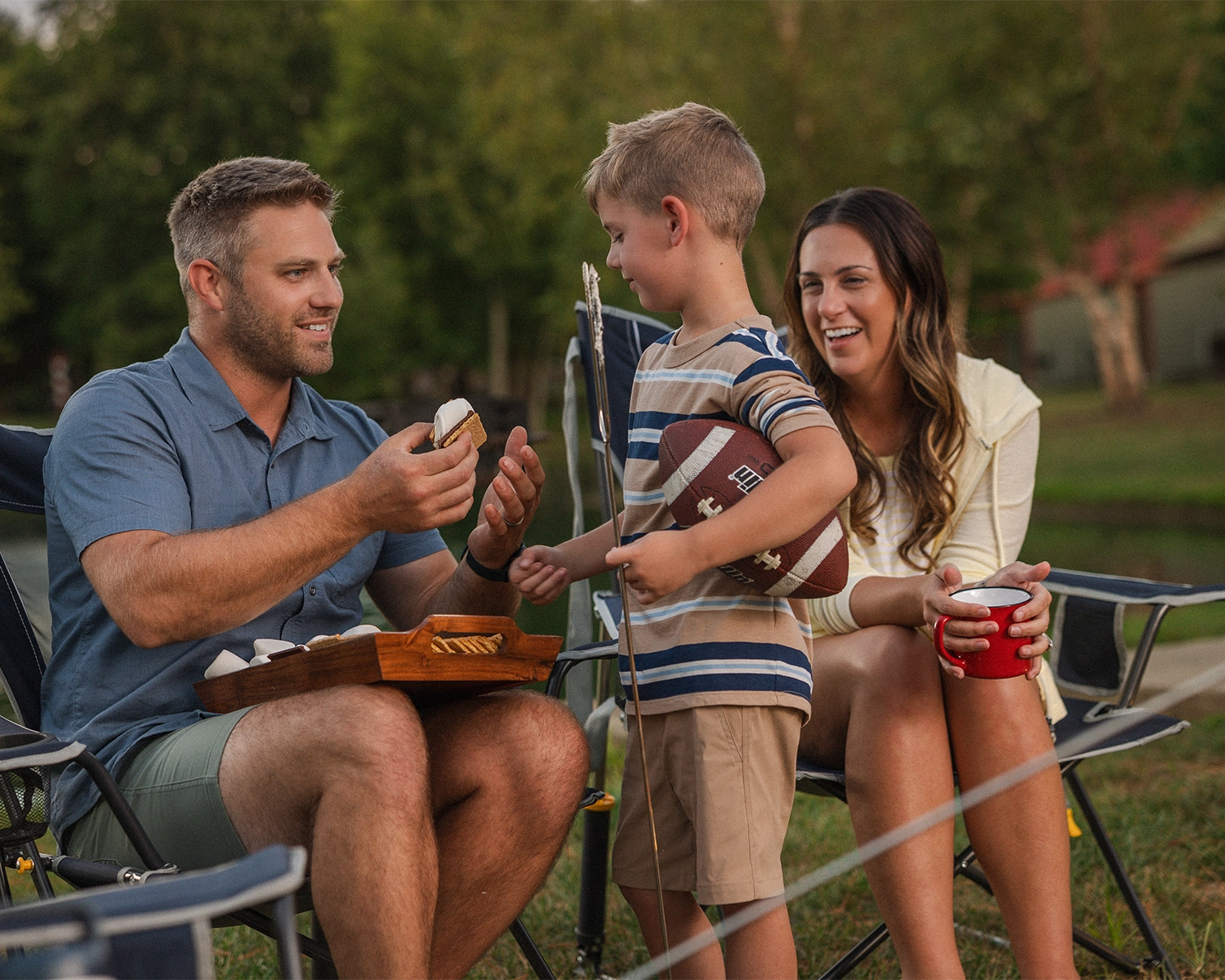 A mother looks on while a father and son make s'mores together at Santa's Cottages in Santa Claus, Indiana.