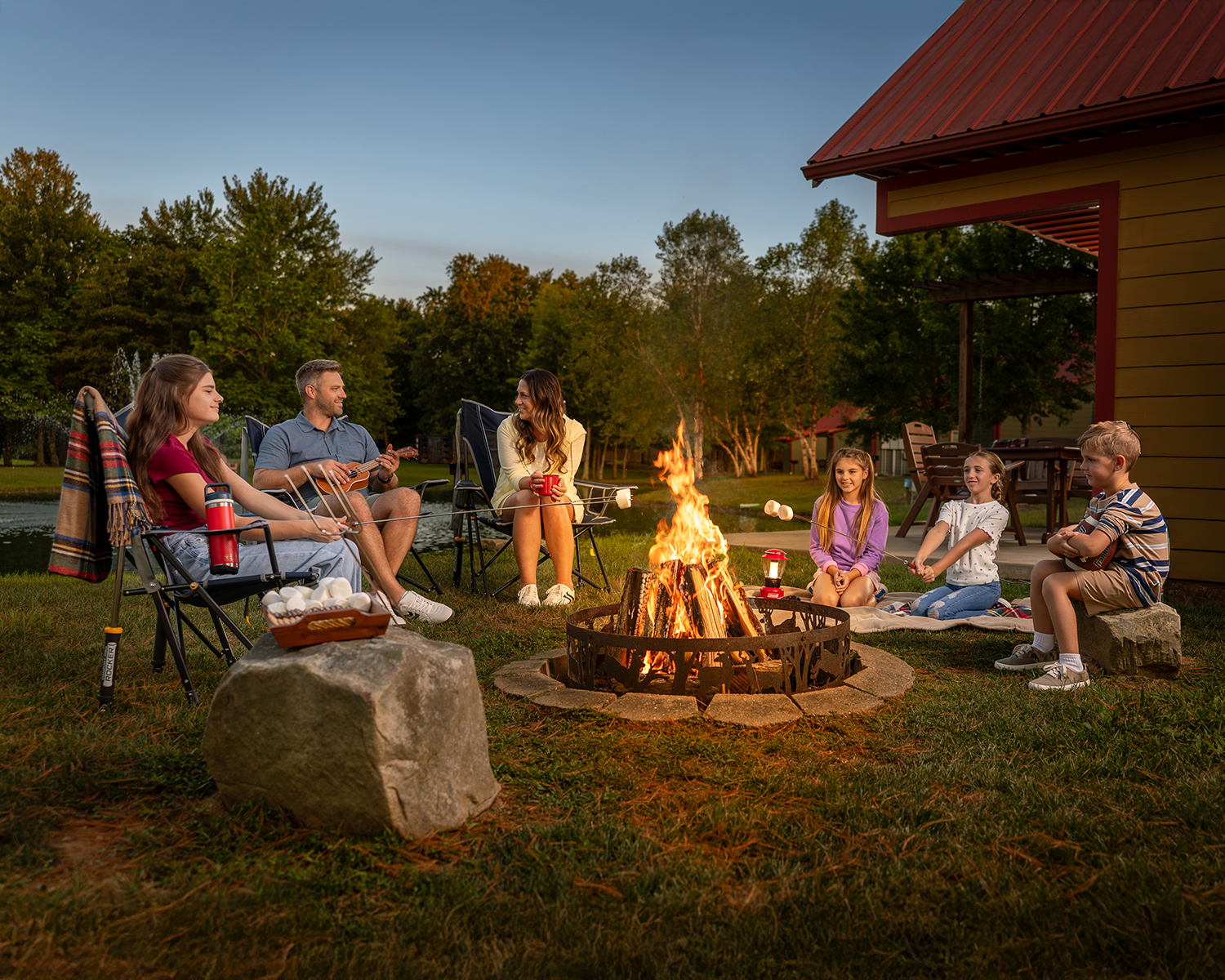 A family roasts marshmallows around the fire pit at Santa's Cottages in Santa Claus, Indiana.