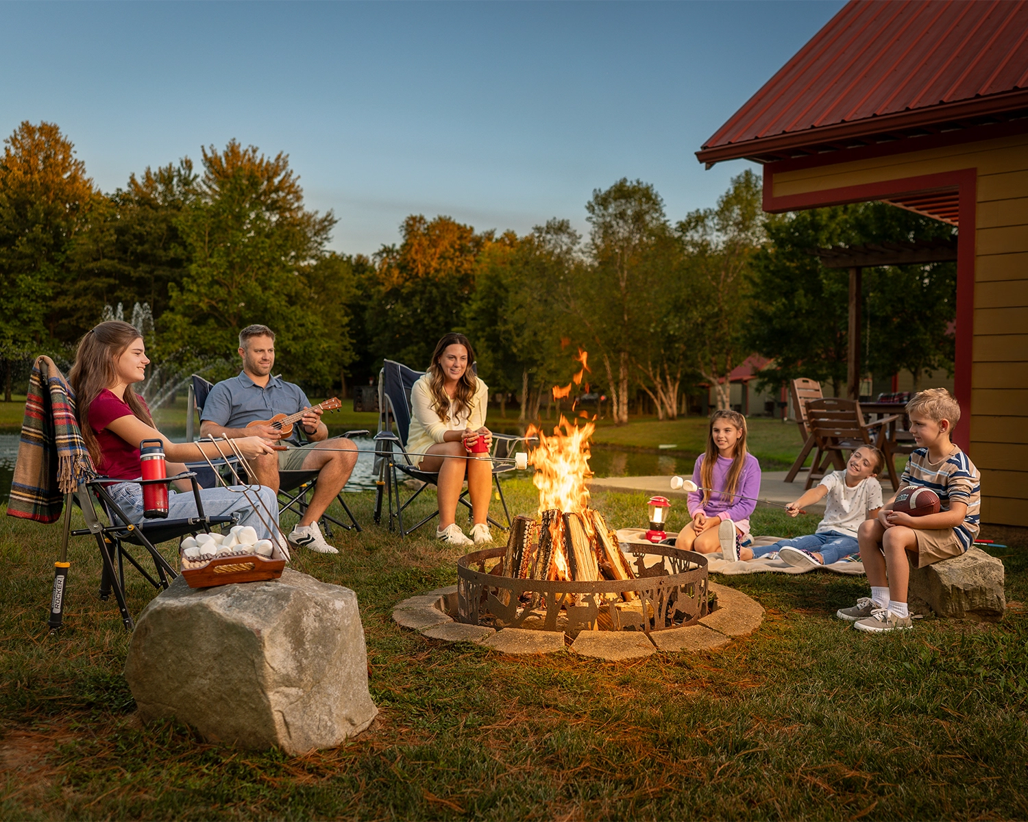 A family roasts marshmallows around the fire pit at Santa's Cottages in Santa Claus, Indiana.