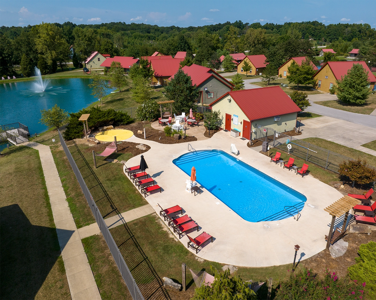 The Swimming Pool & Splash Pad area overlooking a lake at Santa's Cottages in Santa Claus, Indiana.